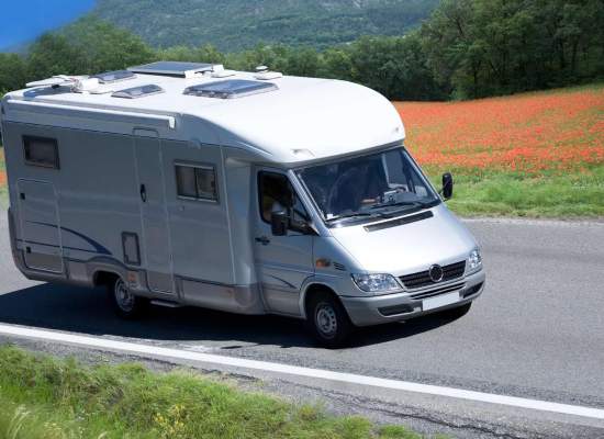A camper van traveling down the highway