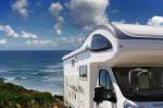 Camper parked overlooking beach and ocean